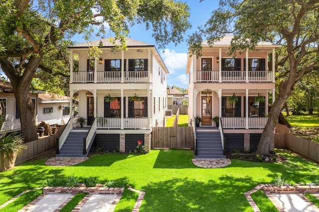 1514 31st St, Galveston, TX 77550 - rear view of property featuring a porch, a balcony, and stairs