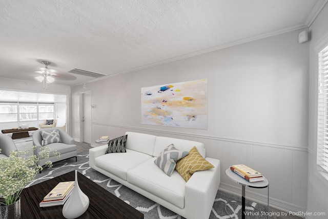 5229 W 43rd St, Houston, TX 77092 - living area featuring a ceiling fan, a wainscoted wall, healthy amount of natural light, and ornamental molding