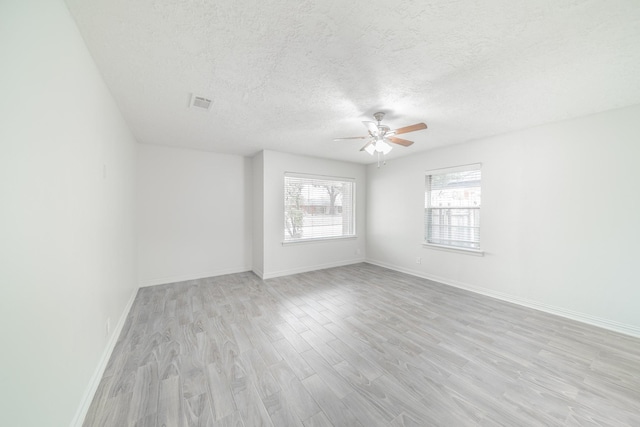 5229 W 43rd St, Houston, TX 77092 - empty room featuring light wood-style floors, a ceiling fan, a textured ceiling, and baseboards