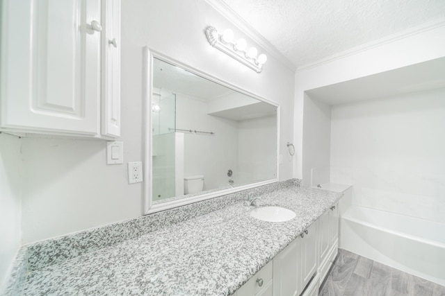 5229 W 43rd St, Houston, TX 77092 - bathroom featuring vanity, toilet, crown molding, a bath, and a textured ceiling