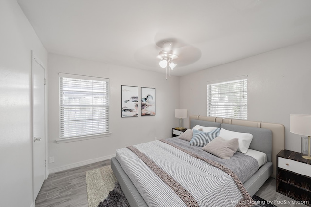 5229 W 43rd St, Houston, TX 77092 - bedroom featuring light wood finished floors, baseboards, and ceiling fan