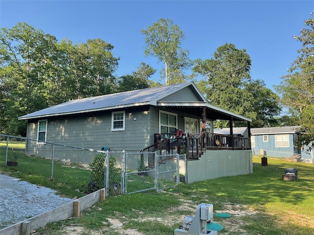 530 Sherwood Forest Dr W, Ivanhoe, TX 75979 - view of side of property featuring a gate, covered porch, and metal roof