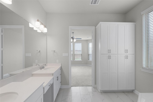 6026 Lake Bridge Ln, Manvel, TX 77578 - full bathroom featuring marble finish flooring, baseboards, vanity, and a ceiling fan