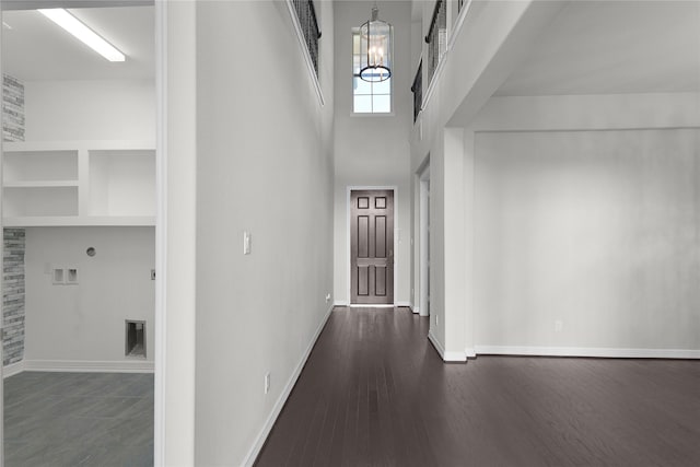 6026 Lake Bridge Ln, Manvel, TX 77578 - entrance foyer with a chandelier, baseboards, dark wood-style flooring, and a high ceiling