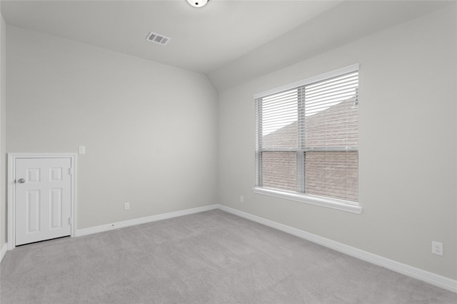 6026 Lake Bridge Ln, Manvel, TX 77578 - unfurnished room featuring light carpet, baseboards, and vaulted ceiling