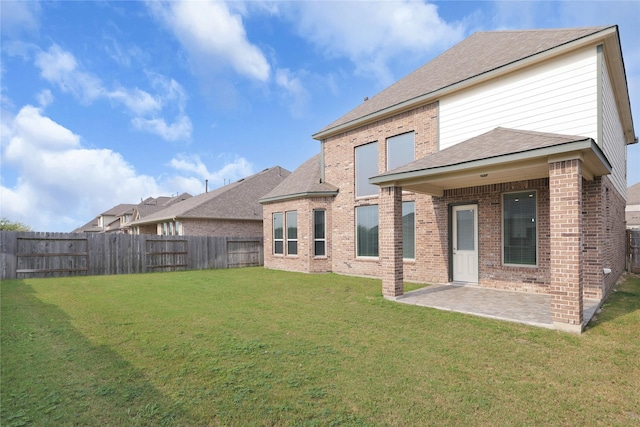 6026 Lake Bridge Ln, Manvel, TX 77578 - back of house with a patio, brick siding, and roof with shingles