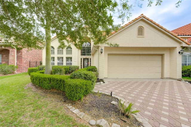 14330 Ayers Rock Rd, Sugar Land, TX 77498 - traditional home featuring a garage, driveway, brick siding, and a front yard