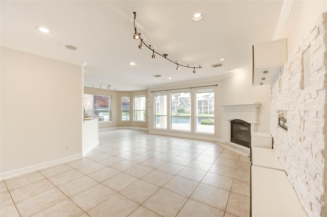 14330 Ayers Rock Rd, Sugar Land, TX 77498 - unfurnished living room with ornamental molding, light tile patterned floors, baseboards, a glass covered fireplace, and recessed lighting