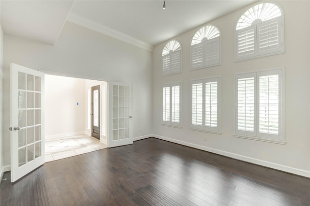 14330 Ayers Rock Rd, Sugar Land, TX 77498 - unfurnished room with french doors, baseboards, healthy amount of natural light, wood finished floors, and crown molding