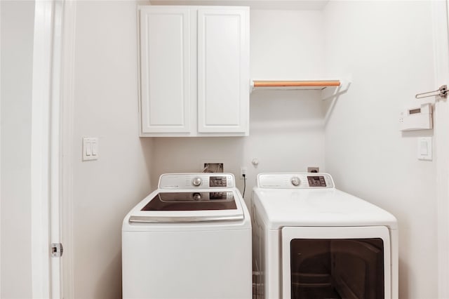 14330 Ayers Rock Rd, Sugar Land, TX 77498 - laundry room featuring washing machine and clothes dryer and cabinet space