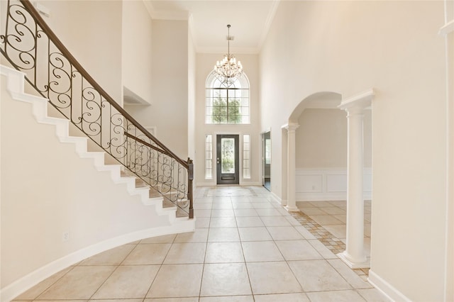 14330 Ayers Rock Rd, Sugar Land, TX 77498 - foyer featuring a high ceiling, stairway, arched walkways, crown molding, and light tile patterned floors