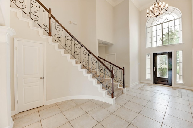 14330 Ayers Rock Rd, Sugar Land, TX 77498 - entryway featuring a towering ceiling, stairs, light tile patterned flooring, baseboards, and a chandelier