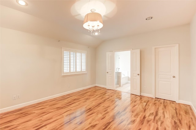 14330 Ayers Rock Rd, Sugar Land, TX 77498 - unfurnished bedroom featuring light wood-style flooring, baseboards, ensuite bath, vaulted ceiling, and recessed lighting