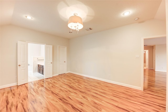 14330 Ayers Rock Rd, Sugar Land, TX 77498 - empty room with vaulted ceiling, a chandelier, light wood finished floors, baseboards, and recessed lighting
