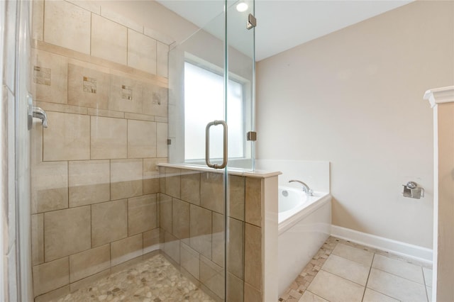14330 Ayers Rock Rd, Sugar Land, TX 77498 - full bathroom featuring a stall shower, a garden tub, tile patterned floors, and baseboards