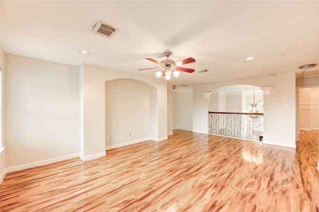 14330 Ayers Rock Rd, Sugar Land, TX 77498 - unfurnished room with ceiling fan, wood finished floors, arched walkways, recessed lighting, and baseboards
