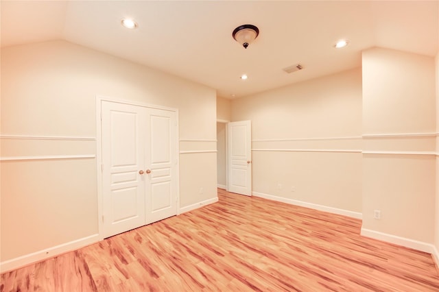 14330 Ayers Rock Rd, Sugar Land, TX 77498 - unfurnished bedroom with vaulted ceiling, light wood-style flooring, recessed lighting, a closet, and baseboards