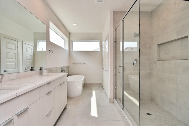 12808 Cozumel Ln, Houston, TX 77045 - full bathroom featuring a shower stall, double vanity, a soaking tub, and tile patterned flooring
