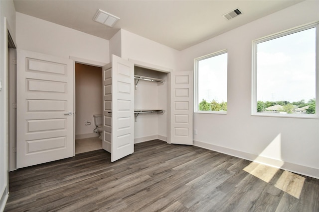 12808 Cozumel Ln, Houston, TX 77045 - unfurnished bedroom featuring dark wood-type flooring, a closet, and baseboards