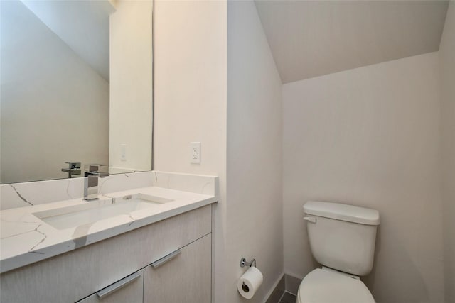 12808 Cozumel Ln, Houston, TX 77045 - half bathroom with vanity, lofted ceiling, toilet, and baseboards
