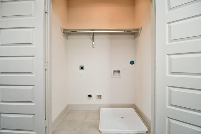 12808 Cozumel Ln, Houston, TX 77045 - laundry area with hookup for an electric dryer, hookup for a washing machine, tile patterned flooring, baseboards, and hookup for a gas dryer