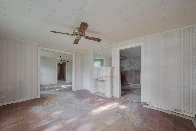 13326 Sundale Rd, Houston, TX 77038 - unfurnished living room featuring hardwood / wood-style flooring, wallpapered walls, ceiling fan, and baseboards