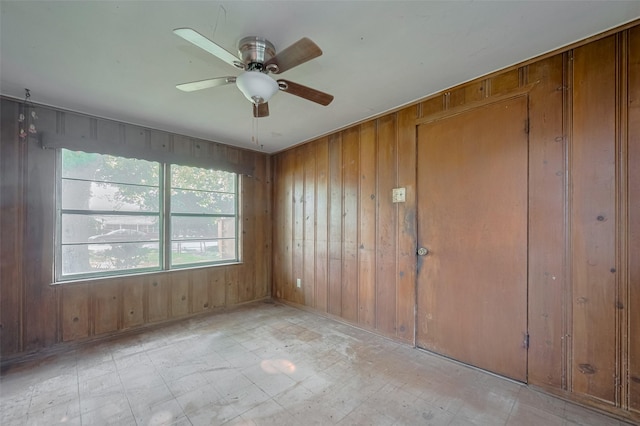 13326 Sundale Rd, Houston, TX 77038 - unfurnished room with light flooring, wood walls, and ceiling fan