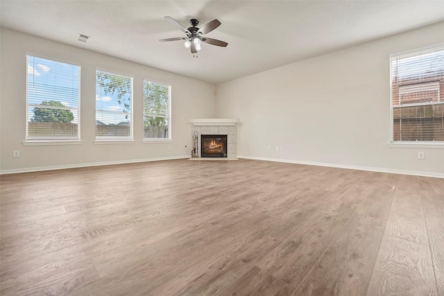 19326 Camellia Knoll Trl, Houston, TX 77084 - unfurnished living room with a ceiling fan, wood finished floors, a fireplace, and baseboards