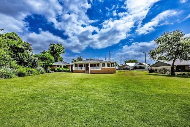 280 Crestmont St, Point Blank, TX 77364 - view of green lawn with a sunroom and a detached carport