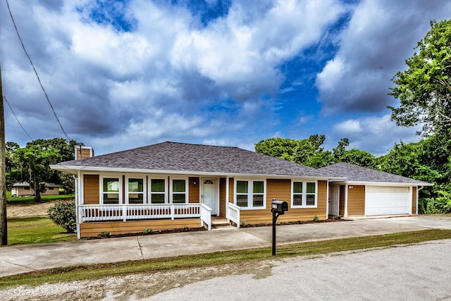 280 Crestmont St, Point Blank, TX 77364 - view of front of house with driveway, a porch, a garage, a chimney, and a shingled roof