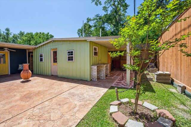 7506 Dearborn St, Houston, TX 77055 - exterior space featuring a patio, board and batten siding, and a ceiling fan