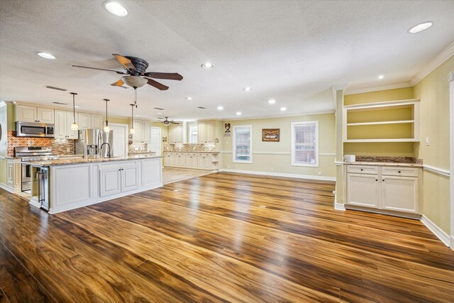 7506 Dearborn St, Houston, TX 77055 - unfurnished living room with ornamental molding, a ceiling fan, wood finished floors, recessed lighting, and a textured ceiling