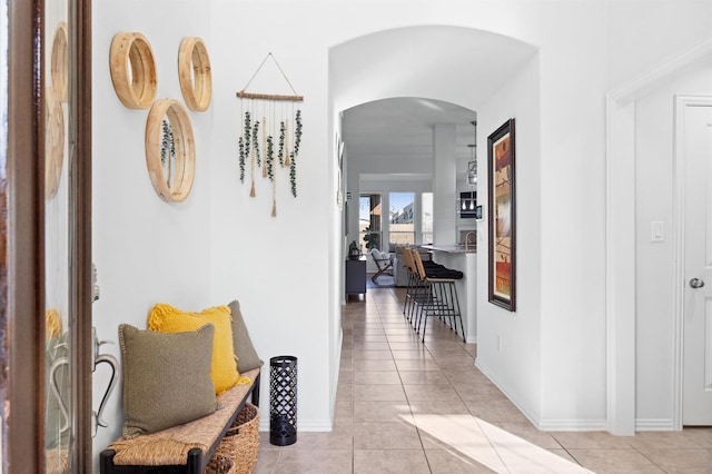 2807 Hadley Spgs, Spring, TX 77386 - hallway with arched walkways, light tile patterned flooring, and baseboards