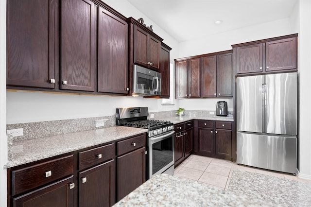 2807 Hadley Spgs, Spring, TX 77386 - kitchen with stainless steel appliances, dark brown cabinets, light tile patterned flooring, and light stone countertops