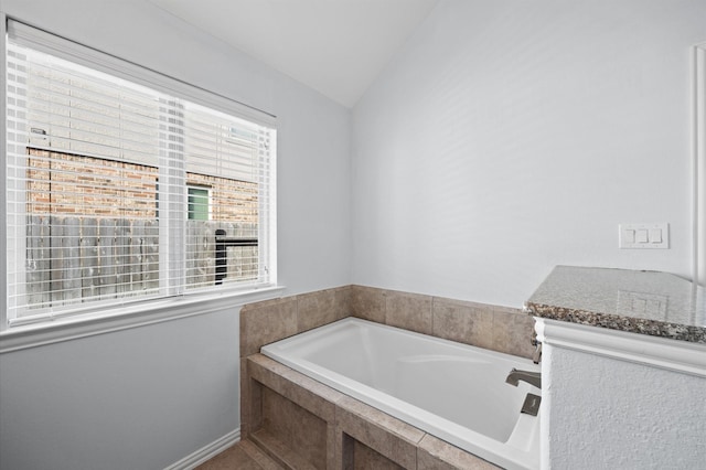 2807 Hadley Spgs, Spring, TX 77386 - bathroom featuring a bath and vaulted ceiling