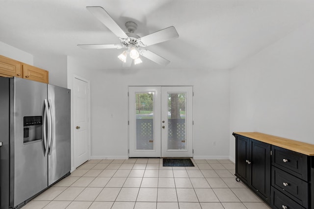 2521 Crosstimbers St Unit A3, Huntsville, TX 77320 - kitchen featuring stainless steel fridge, baseboards, dark cabinetry, and french doors