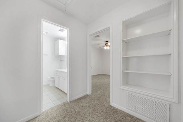 2521 Crosstimbers St Unit A3, Huntsville, TX 77320 - hall featuring light carpet, attic access, baseboards, and built in features