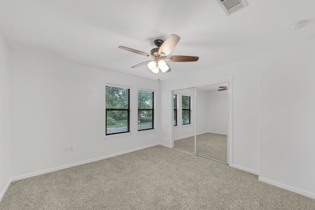 2521 Crosstimbers St Unit A3, Huntsville, TX 77320 - unfurnished bedroom featuring carpet floors, a closet, baseboards, and a ceiling fan