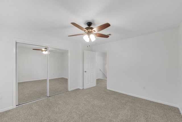 2521 Crosstimbers St Unit A3, Huntsville, TX 77320 - unfurnished bedroom featuring carpet, baseboards, ceiling fan, and a closet