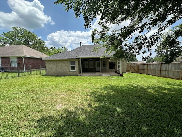 243 Fantasy Ln, Montgomery, TX 77356 - back of property with brick siding, a patio, and a shingled roof
