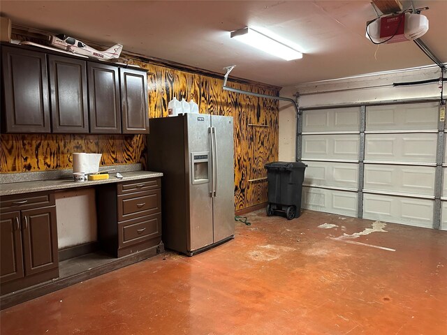 243 Fantasy Ln, Montgomery, TX 77356 - garage featuring stainless steel fridge with ice dispenser and a garage door opener