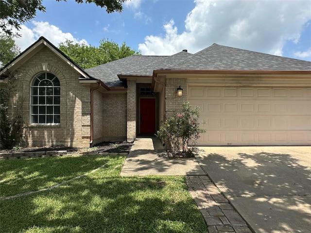 243 Fantasy Ln, Montgomery, TX 77356 - view of front of property featuring a shingled roof, a garage, concrete driveway, a front yard, and brick siding