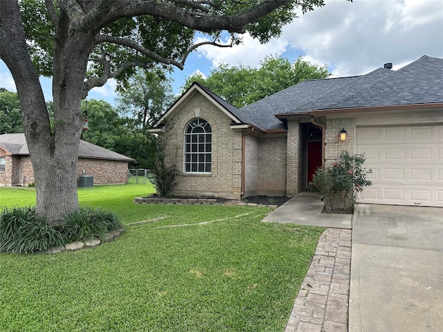 243 Fantasy Ln, Montgomery, TX 77356 - single story home featuring roof with shingles, a front lawn, an attached garage, brick siding, and cooling unit