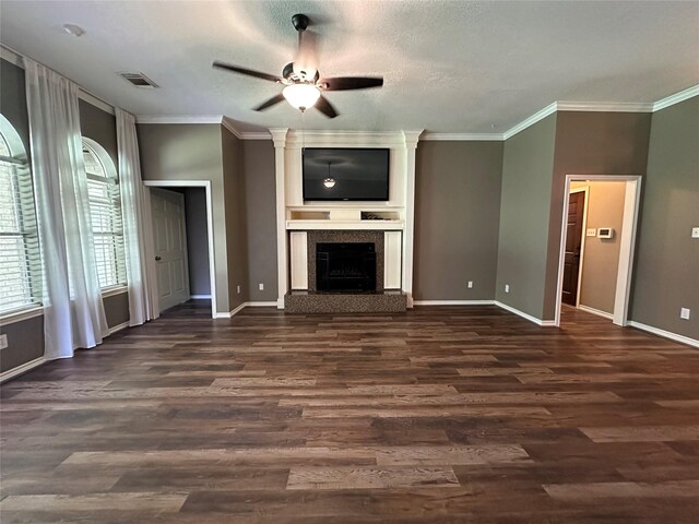 243 Fantasy Ln, Montgomery, TX 77356 - unfurnished living room with ceiling fan, crown molding, dark wood-type flooring, baseboards, and a fireplace with raised hearth