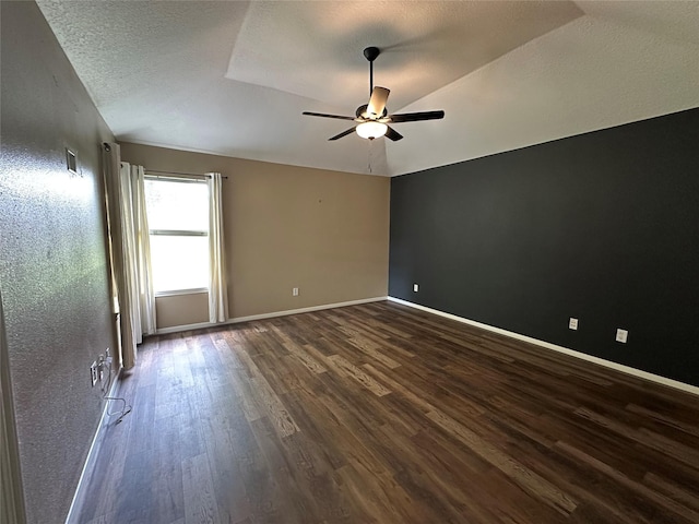 243 Fantasy Ln, Montgomery, TX 77356 - unfurnished room with dark wood-style flooring, ceiling fan, vaulted ceiling, a textured ceiling, and baseboards