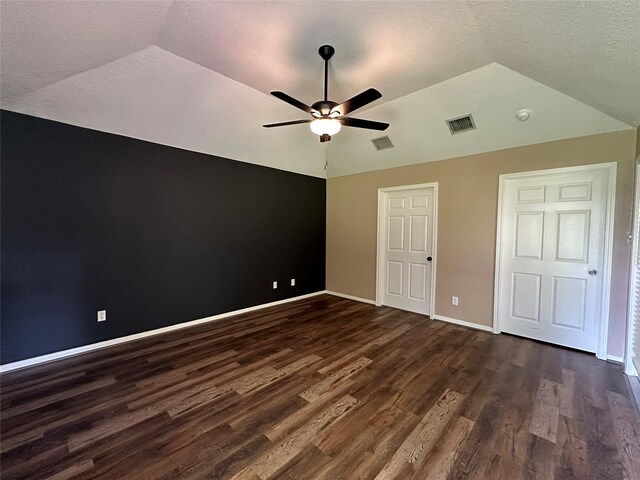 243 Fantasy Ln, Montgomery, TX 77356 - unfurnished bedroom featuring lofted ceiling, dark wood finished floors, baseboards, a textured ceiling, and ceiling fan