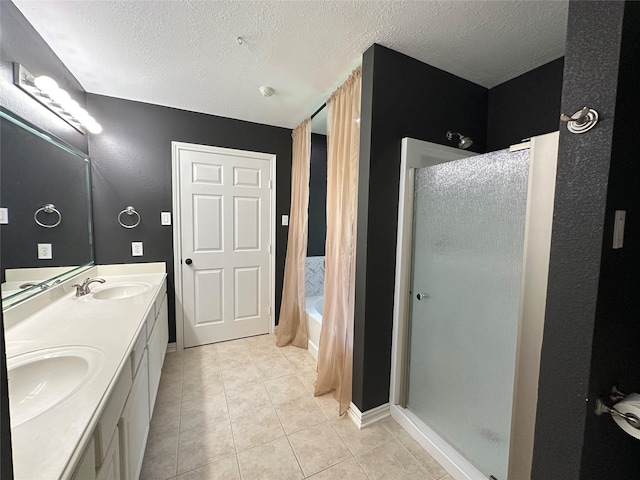 243 Fantasy Ln, Montgomery, TX 77356 - full bathroom featuring a textured ceiling, an enclosed shower, double vanity, tile patterned floors, and a tub to relax in