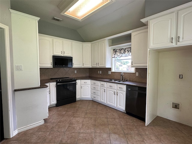 243 Fantasy Ln, Montgomery, TX 77356 - kitchen featuring black appliances, a sink, dark countertops, decorative backsplash, and vaulted ceiling