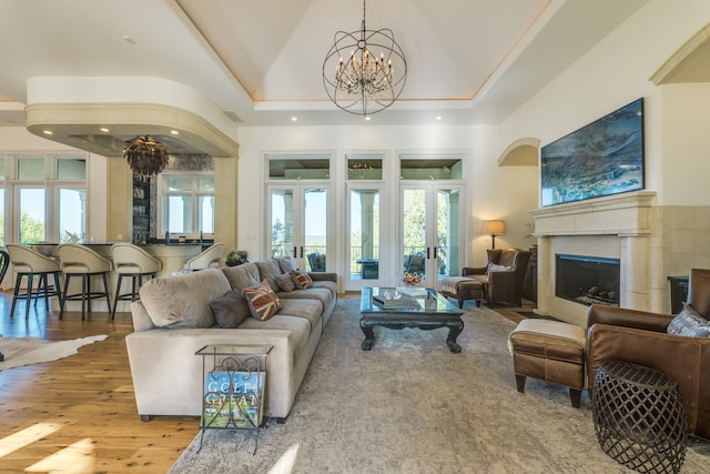 115 Hidden Hills Dr, Spicewood, TX 78669 - living area featuring a chandelier, french doors, wood finished floors, a fireplace, and recessed lighting