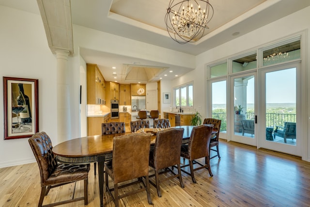 115 Hidden Hills Dr, Spicewood, TX 78669 - dining room with a raised ceiling, light wood-type flooring, a chandelier, recessed lighting, and baseboards